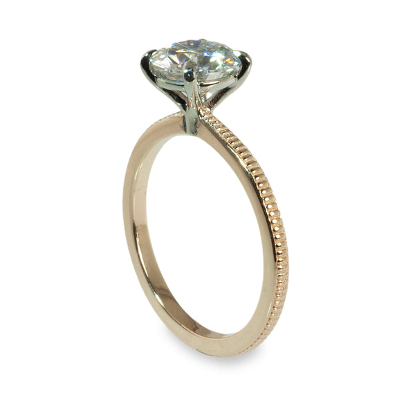 Coin edged solitaire engagement ring