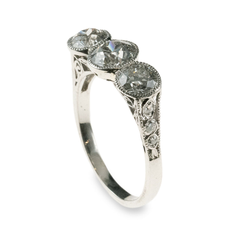 An antique 1920s-era platinum hand-fabricated filigree 3-diamond ring