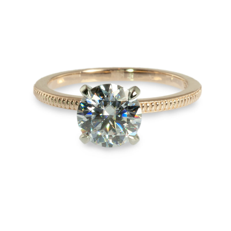 Coin edged solitaire engagement ring
